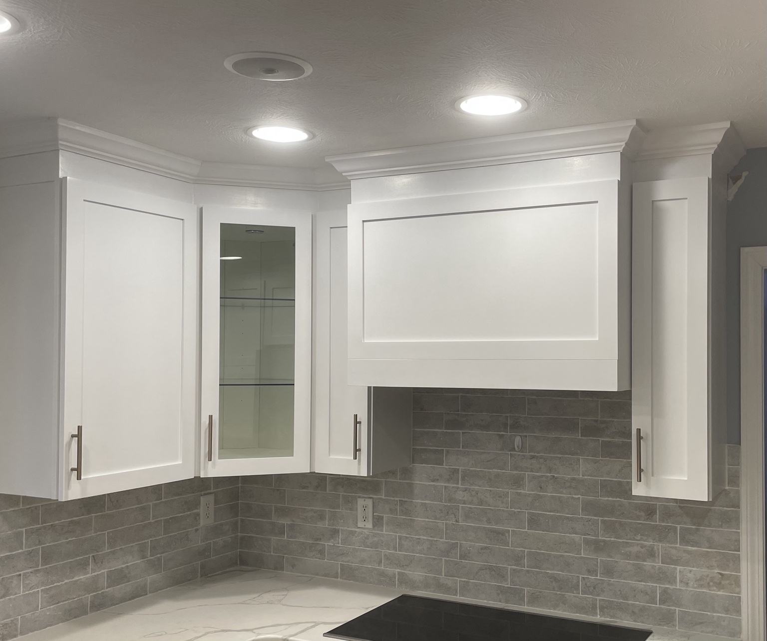 Kitchen with bright white cabinet finish and updated hardware